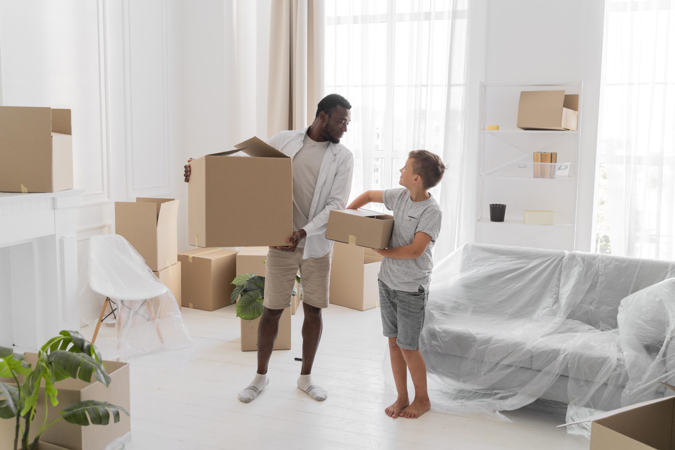https://global-advice.ch/wp-content/uploads/2024/07/boy-helping-his-father-carry-packages-moving-out-scaled.jpg
